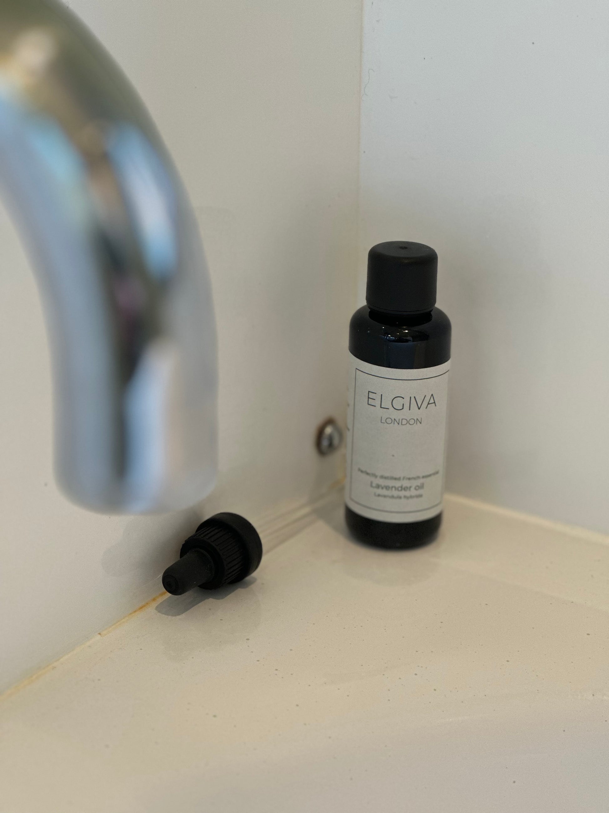 50ml Elgiva London lavender oil in a dark purple glass bottle with a screw top beside a screw in pipette dropper