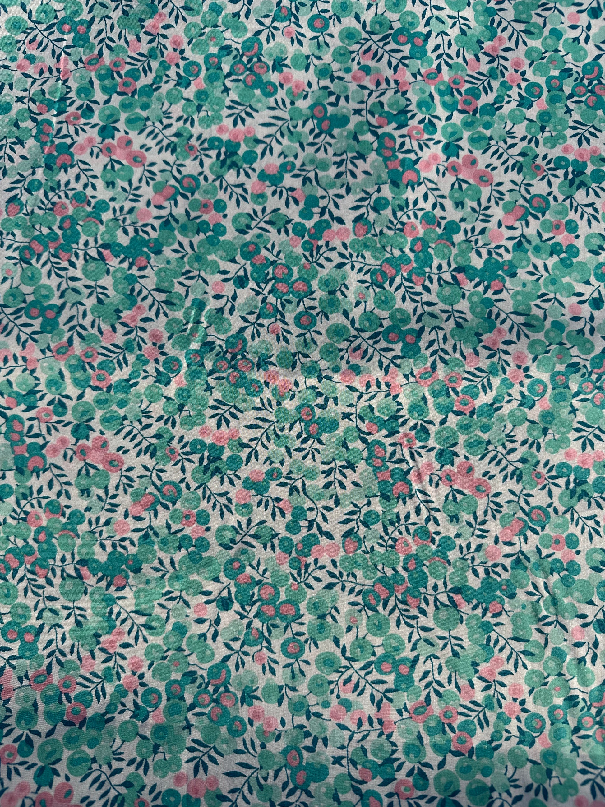 Liberty print fabric: floral patterned with small turquoise and pink flowers on a light background