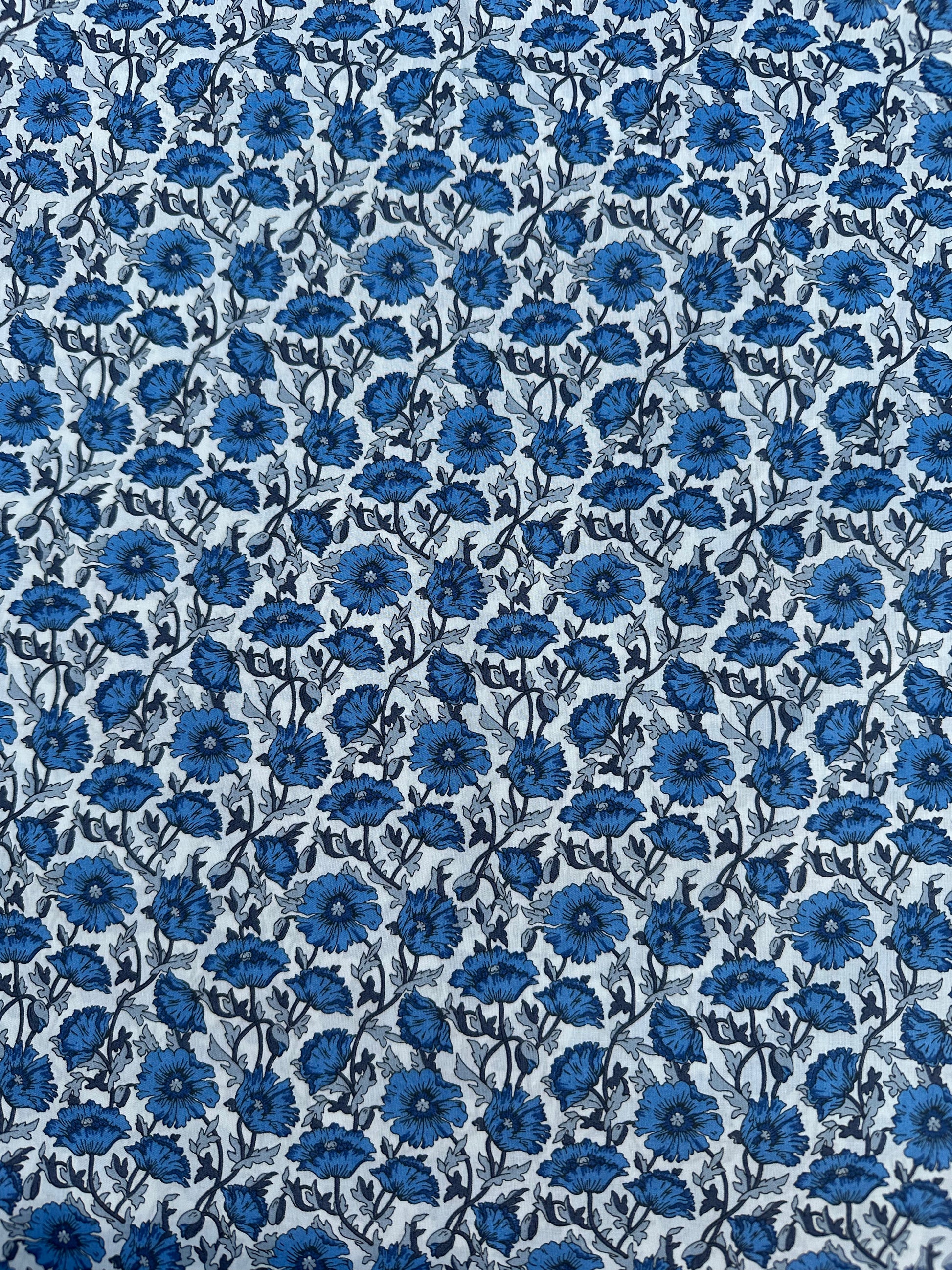 Liberty print fabrick with cobalt blue flowers on a light background