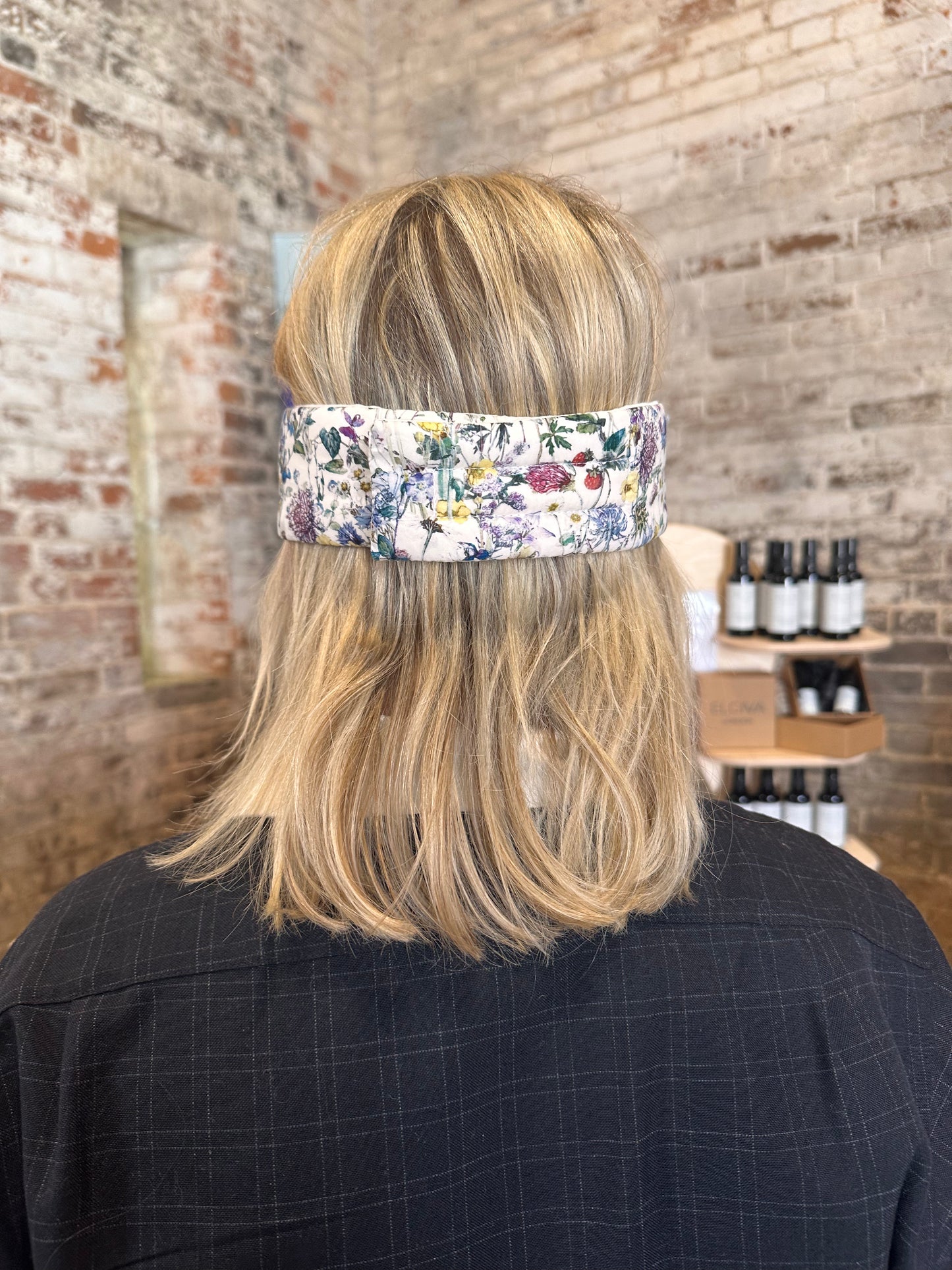 The Elgiva Sleep Mask - adjustable for all head sizes - model wearing it showing the fastening at back of head 