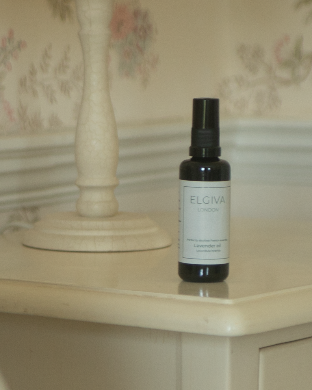 Elgiva London 50ml lavender oil bottle styled on a bedside table, vertical crop