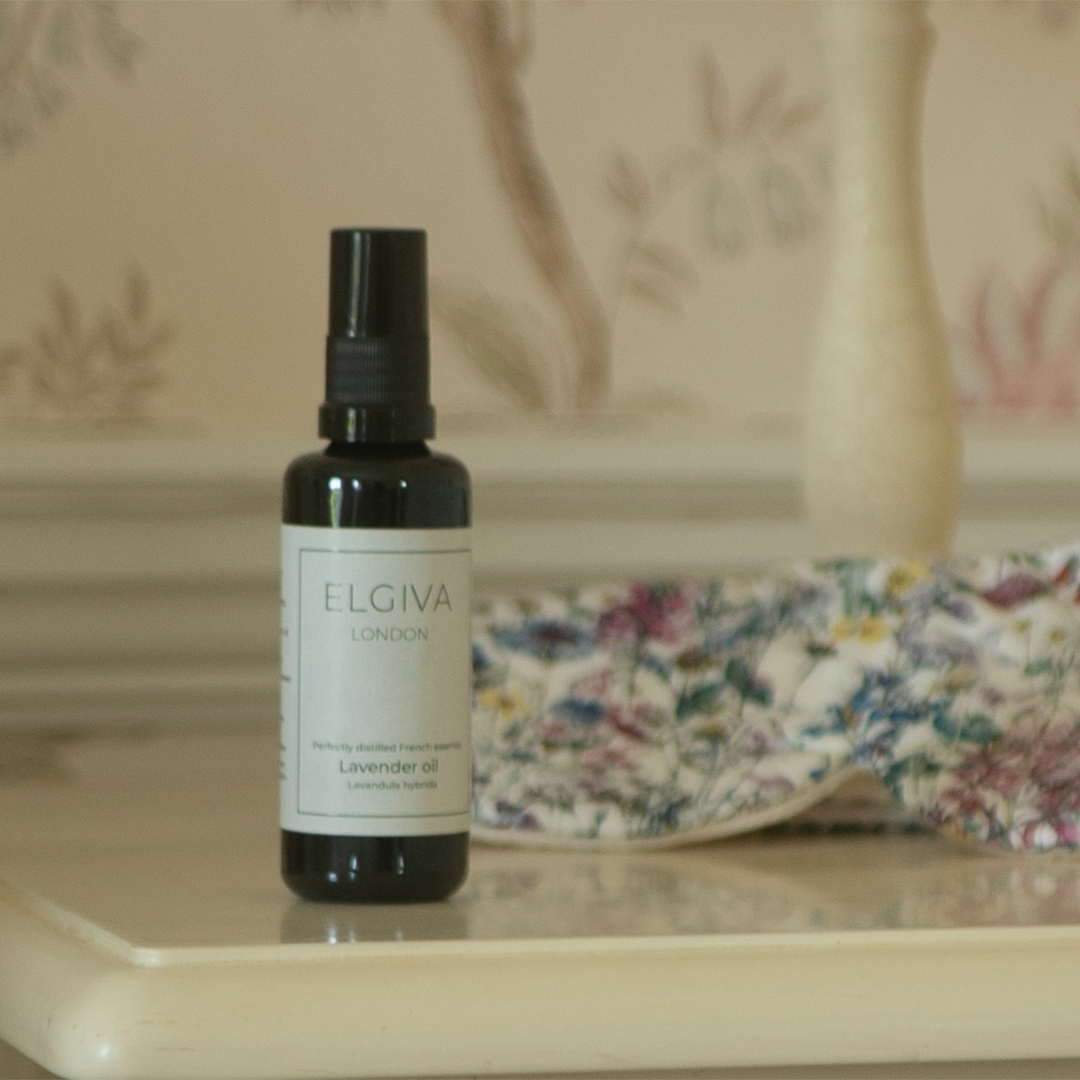 Elgiva London 50ml lavender oil bottle styled on a bedside table with a sleep eye mask, square crop