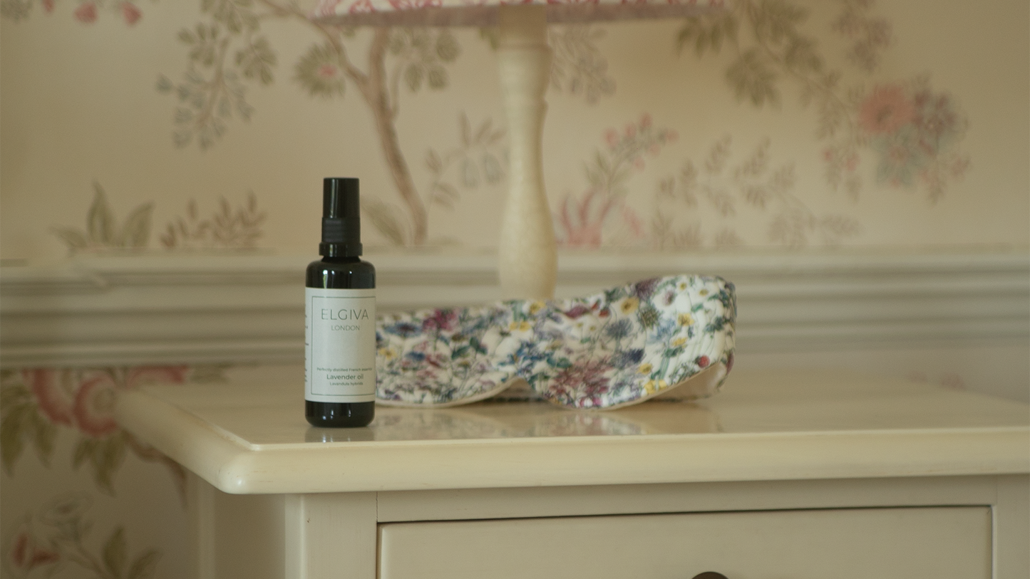 Elgiva London 50ml lavender oil bottle styled on a bedside table with a sleep eye mask