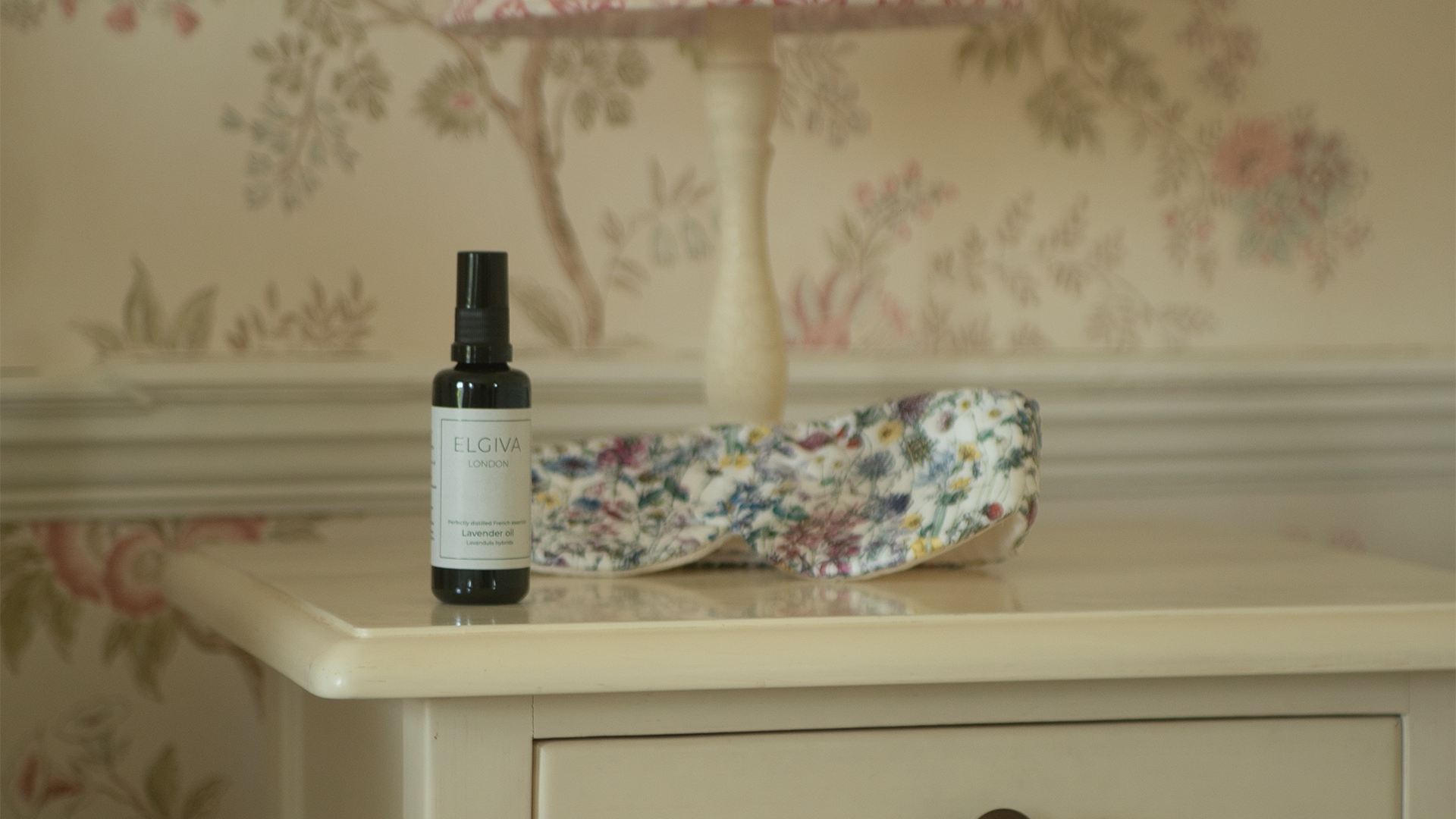 Elgiva London 50ml lavender oil bottle styled on a bedside table with a sleep eye mask